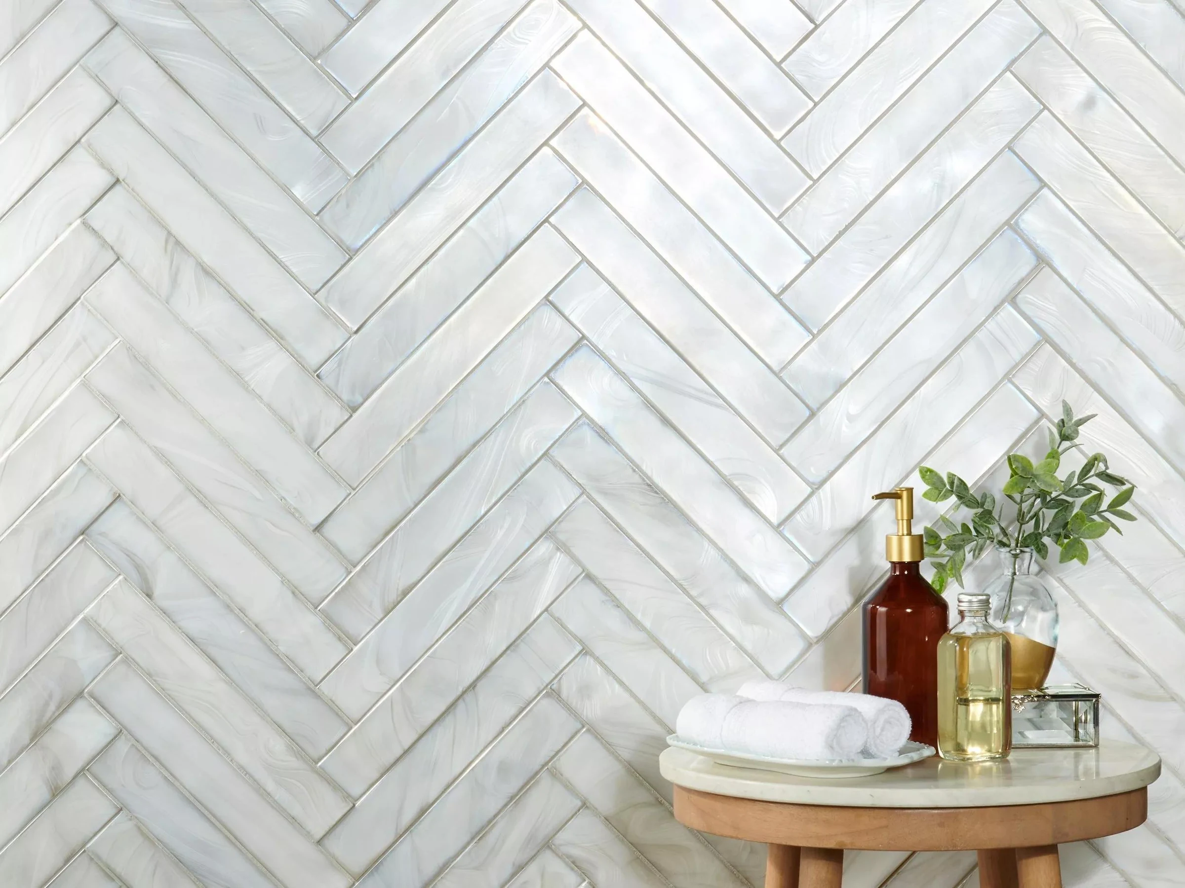 Pearl herringbone mosaic installed in a bathroom setting